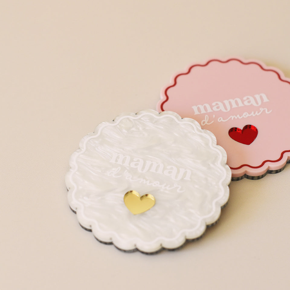 Miroir de poche forme rond festonné avec impression contour, inscription « maman d’amour » et coeur en plexi miroir incrusté au centre. Un coloris rose et rouge (fond plexi rose, contour rouge, texte blanc, coeur en plexi miroir rouge)
Un coloris marbré blanc (fond plexi marbré blanc, contour et teste blanc, coeur en plexi miroir or)